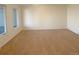 A carpeted bedroom gets lots of natural light from a window in the back of the home at 1703 S Moline Ct, Aurora, CO 80012