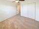 Neutral, carpeted bedroom with sliding closet doors and ceiling fan at 1703 S Moline Ct, Aurora, CO 80012