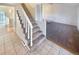 Welcoming entryway with tiled floor, carpeted stairs, and open floor plan at 1703 S Moline Ct, Aurora, CO 80012