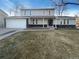 Charming two-story home with a well-manicured lawn and attached two-car garage at 1703 S Moline Ct, Aurora, CO 80012