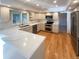 Modern kitchen with marble countertops, stainless steel appliances, and an island and light wood flooring at 1703 S Moline Ct, Aurora, CO 80012