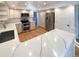 Modern kitchen featuring stainless steel appliances, marble countertops, and light wood flooring at 1703 S Moline Ct, Aurora, CO 80012