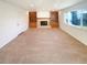 Spacious, carpeted living room with built-in shelving, fireplace, and ample natural light at 1703 S Moline Ct, Aurora, CO 80012