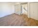 Living room area with built-in shelves, carpet, and an open doorway to stairs at 1703 S Moline Ct, Aurora, CO 80012