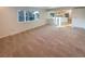 Carpeted living room filled with natural light featuring neutrally painted walls at 1703 S Moline Ct, Aurora, CO 80012
