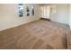 Well-lit living room with a large window and neutrally painted walls and carpeted floor at 1703 S Moline Ct, Aurora, CO 80012