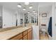 Primary bathroom includes a granite vanity, mirrored walls, and a separate toilet room with a tile floor at 4570 E Yale Ave # 1104, Denver, CO 80222
