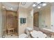 Bathroom featuring a tiled shower with a bench and a flower-shaped sink at 4570 E Yale Ave # 1104, Denver, CO 80222