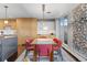 Bright dining room with modern lighting, glass table, and access to the outdoor patio area at 4570 E Yale Ave # 1104, Denver, CO 80222
