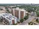 Condominium building with adjacent parking in the neighborhood with lots of trees at 4570 E Yale Ave # 1104, Denver, CO 80222