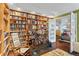 Cozy living room with a wall of bookshelves and an open doorway to the kitchen at 4570 E Yale Ave # 1104, Denver, CO 80222