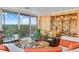 Open living room with a balcony overlooking the mountains, and custom wood built-ins at 4570 E Yale Ave # 1104, Denver, CO 80222