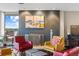 Comfortable living room with a stylish brick fireplace, plush seating, and an incredible view from the balcony at 4570 E Yale Ave # 1104, Denver, CO 80222