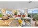 Modern living room with an adjacent dining area, a balcony and views of the mountains at 4570 E Yale Ave # 1104, Denver, CO 80222