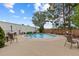 Community outdoor pool surrounded by a concrete deck, lounge chairs, and landscaping for relaxation at 4570 E Yale Ave # 1104, Denver, CO 80222