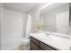 This full bathroom features a shower-tub combo and a large vanity with ample counter space at 4760 Kittredge St, Denver, CO 80239