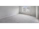 Spacious bedroom features plush carpeting and two large windows providing lots of natural light at 4760 Kittredge St, Denver, CO 80239