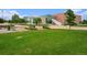 Modern building set against a green lawn with landscaped area at 4760 Kittredge St, Denver, CO 80239
