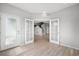 Welcoming foyer featuring light hardwood floors, a bright white door, and open access to the upper levels at 4760 Kittredge St, Denver, CO 80239