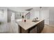 Modern kitchen features a large island, stainless steel appliances, and light wood flooring at 4760 Kittredge St, Denver, CO 80239