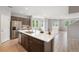 Spacious kitchen with modern island, stainless steel appliances, and ample cabinet space in a light-filled setting at 4760 Kittredge St, Denver, CO 80239