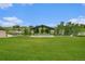 Scenic park view featuring a covered stage area and lush green grass by the water at 4760 Kittredge St, Denver, CO 80239