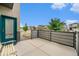 Private patio with wood-look fence offering a cozy outdoor living space next to the front door at 4760 Kittredge St, Denver, CO 80239