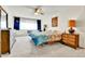Bright bedroom featuring a ceiling fan, carpet, and a large window at 710 S Alton Way # 5A, Denver, CO 80247