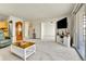 Open living room featuring neutral carpet, updated lighting, and access to balcony at 710 S Alton Way # 5A, Denver, CO 80247