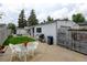 Patio area with seating, barbecue grill, and manicured lawn in the backyard at 1256 Ulster St, Denver, CO 80220