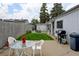 Backyard patio with a table and chairs, a barbecue grill, and landscaped areas at 1256 Ulster St, Denver, CO 80220