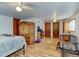 Spacious bedroom with hardwood floors, warm lighting, neutral tones, and a comfortable setup for relaxation and rest at 1256 Ulster St, Denver, CO 80220