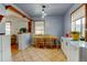 Bright dining space featuring tile floors, wooden furniture, and ample natural light from two large windows at 1256 Ulster St, Denver, CO 80220
