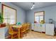 Cozy dining area with light-colored walls, tile floor, and natural wood table near plentiful natural light at 1256 Ulster St, Denver, CO 80220
