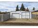 Spacious detached garage with two large doors, ample parking, and potential for storage or workshop space at 1256 Ulster St, Denver, CO 80220
