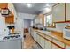 Classic kitchen with wood countertops, tile floor, and white cabinets, providing a welcoming and functional space at 1256 Ulster St, Denver, CO 80220