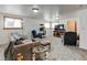 Spacious living room with plush carpeting, comfortable seating, and ample natural light from multiple windows at 1256 Ulster St, Denver, CO 80220