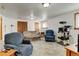 A comfortable living area offers plush seating, a cat tree, and a serene space for relaxing and leisure at 1256 Ulster St, Denver, CO 80220