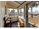 Bright sunroom featuring large windows and rustic bench, ideal for relaxation and enjoying natural light at 1256 Ulster St, Denver, CO 80220