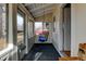 Enclosed porch featuring large windows and a cozy swing, perfect for enjoying the outdoors in comfort at 1256 Ulster St, Denver, CO 80220