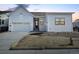 Charming single-Gathering home with modern farmhouse exterior, large windows and an attached two car garage at 11442 Autumn Moon St, Littleton, CO 80125