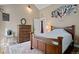Well-lit bedroom boasts hardwood floors, complemented by a dresser and comfortable queen sized bed at 96 Greeley Blvd, Palmer Lake, CO 80133