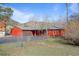 Charming red house with a front porch, brown garage door, and beautiful mountain views at 96 Greeley Blvd, Palmer Lake, CO 80133
