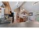Kitchen with oak cabinets, breakfast bar, stainless appliances, and views to living and dining areas at 96 Greeley Blvd, Palmer Lake, CO 80133