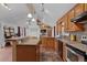 Open kitchen featuring oak cabinets, a breakfast bar, and a view to the living area at 96 Greeley Blvd, Palmer Lake, CO 80133
