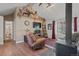 Cozy living room with hardwood floors, fireplace, and large window offering ample natural light at 96 Greeley Blvd, Palmer Lake, CO 80133