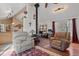 Bright living room with vaulted ceilings, wood stove, and lots of natural light at 96 Greeley Blvd, Palmer Lake, CO 80133
