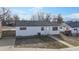 Exterior view of a white one-story home with a well-kept lawn and backyard at 1345 S Meade St, Denver, CO 80219