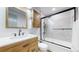 Well-lit bathroom with a modern sink, vanity, and bathtub-shower combo at 1345 S Meade St, Denver, CO 80219