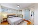 Cozy bedroom with wood floors, a neutral color palette, and plenty of natural light at 1345 S Meade St, Denver, CO 80219